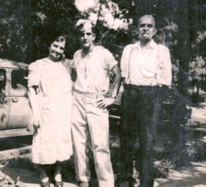 A man and two women standing next to each other.