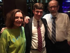 A man and two women posing for the camera.