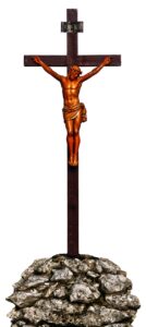 A wooden walking stick with a statue of jesus.